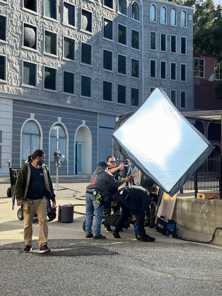 Production crew prepping camera and lighting gear for a corporate shoot